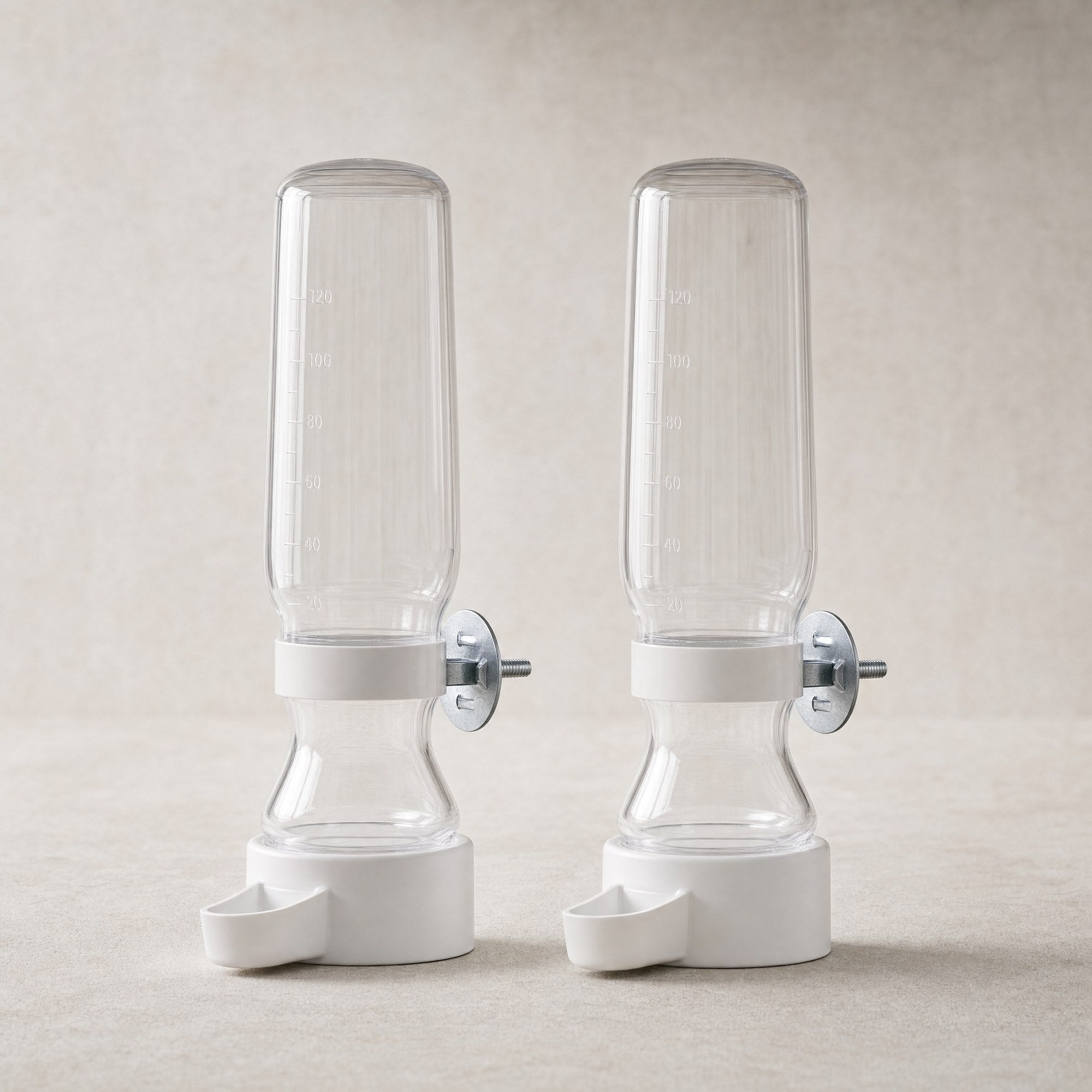A pair of clear bird cage water feeders with white bases